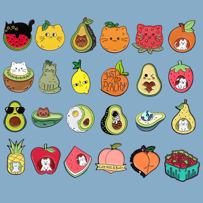 Close-up of a colourful cartoon strawberry metal brooch with a safety-pin clasp, on a denim jacket pocket.