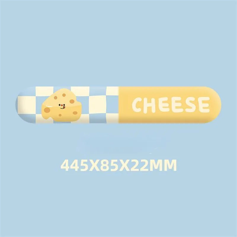 Cartoon cheese wrist rest mouse pad with keyboard holder placed on a wooden desk next to a notebook computer