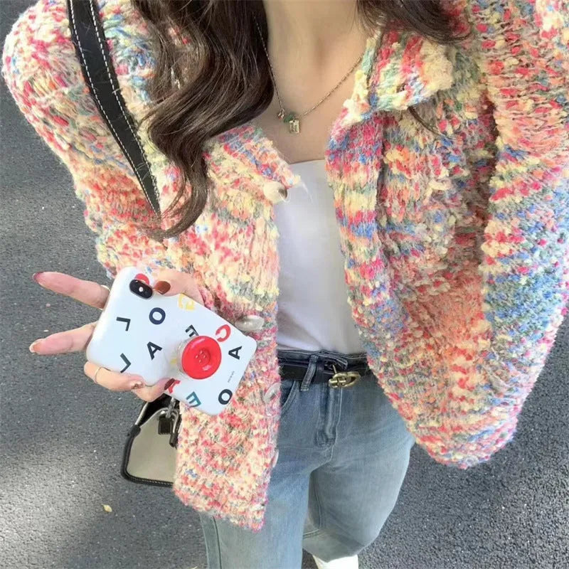 Pink and green rainbow pattern knitted cardigan on a hanger, showing slim fit and regular sleeves.