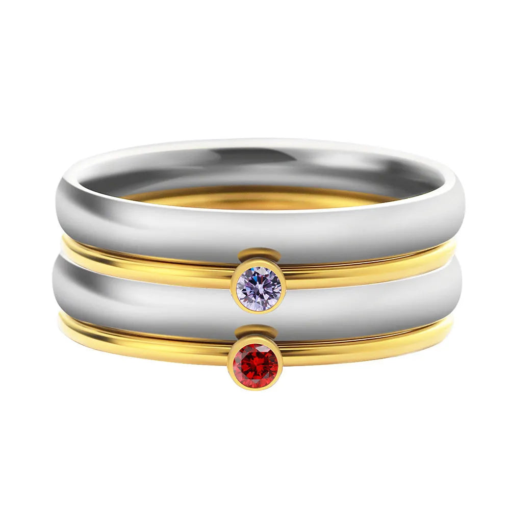 Close-up of a titanium steel engraved ring with a December colour birthstone, showing geometric design.