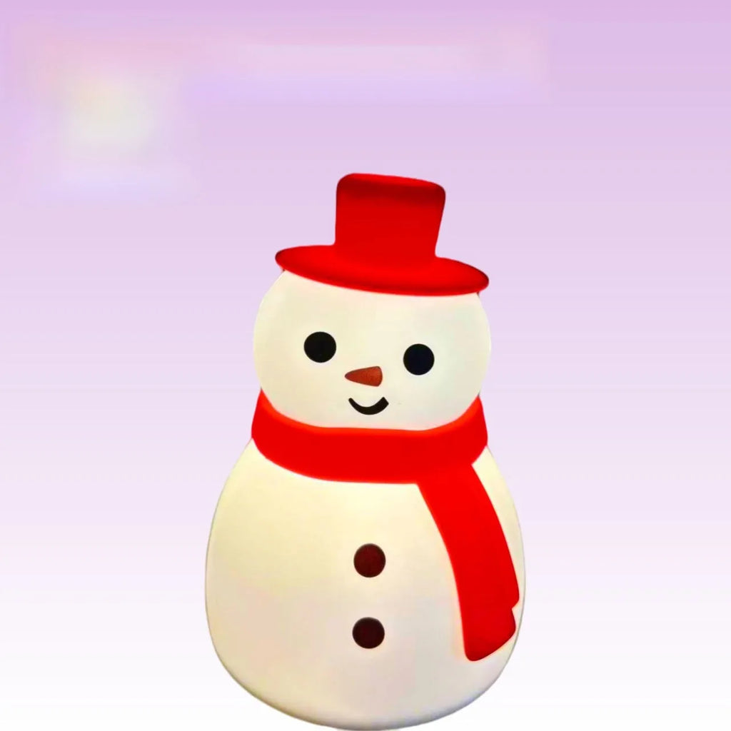 Cartoon snowman shaped silicone night lamp with warm light on a desk