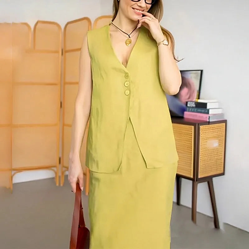 A woman modelling a blue sleeveless vest and matching long skirt from a casual two-piece suit.