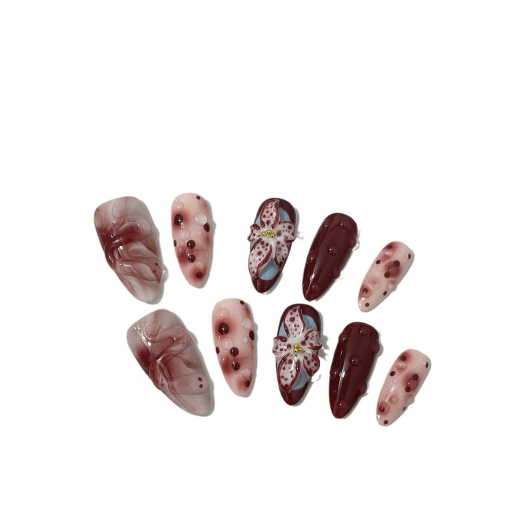 Hand-painted 3D sculpted press-on false nails with multiple patterns in almond shape