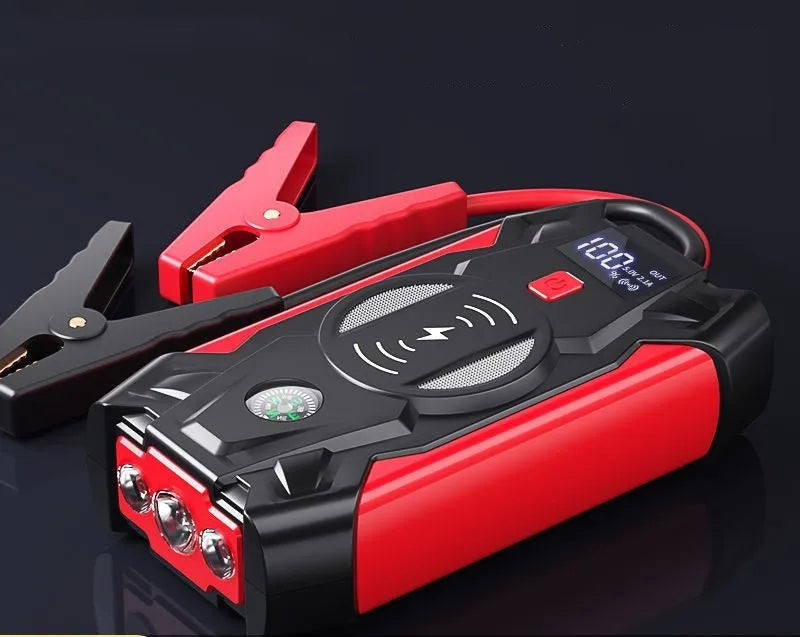 Red car emergency jump starter power pack with digital display and air pump inside a storage case.