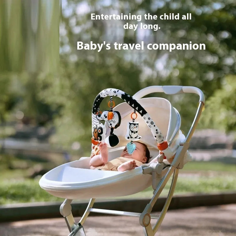 Baby lathe clip hanging plush toy in black and white, with pull vibration teether and BB call, attached to a cot side