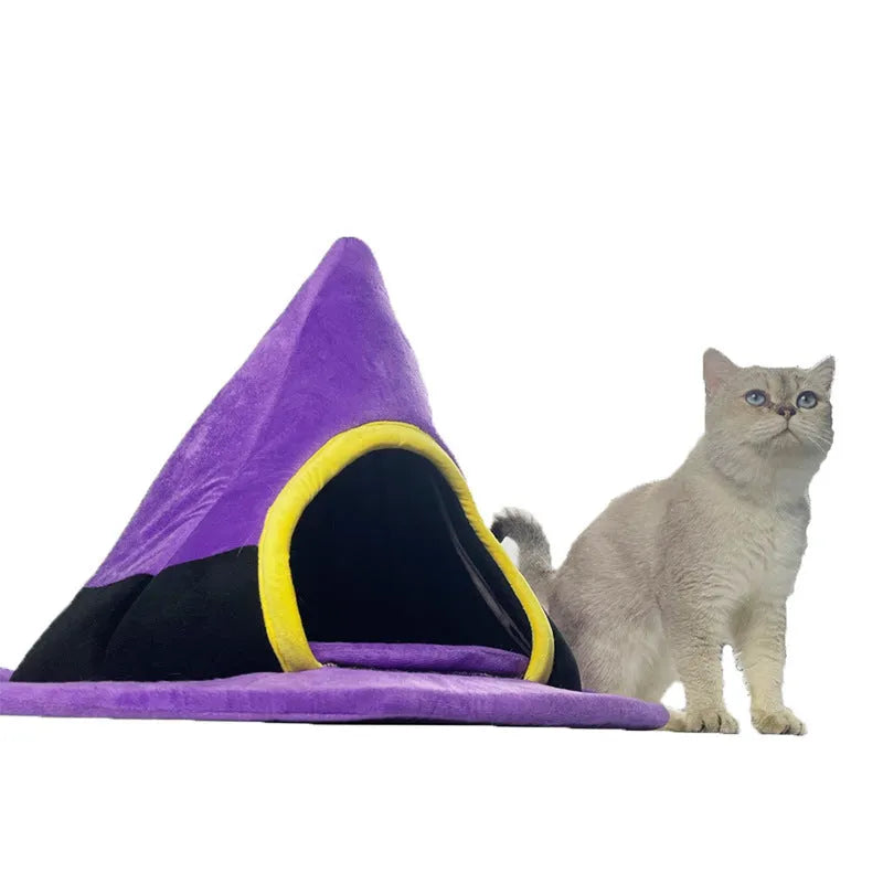 Purple cloth Halloween witch hat shaped cat bed measuring 60 by 45 cm.