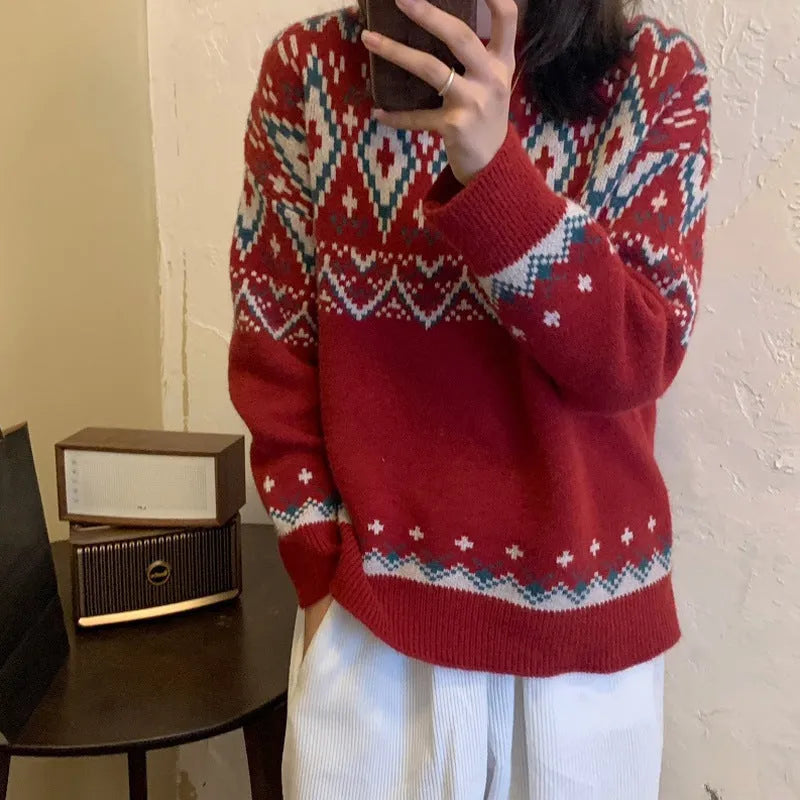Red and white striped loose-fit knitted pullover with long sleeves on a model.
