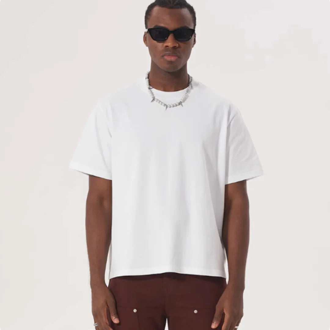 Man wearing a loose fit apricot coloured pure cotton T-shirt with short sleeves.