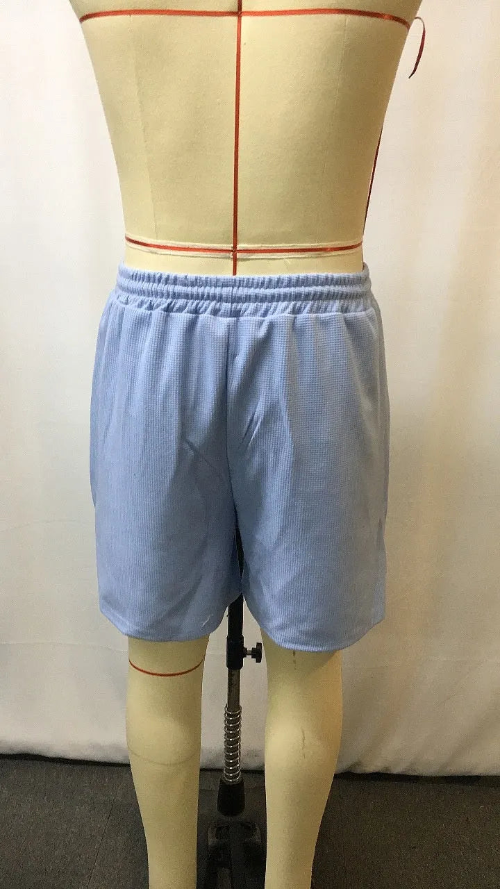 Men's light blue retro waffle knitted stretch surfing shorts with wide leg, front view