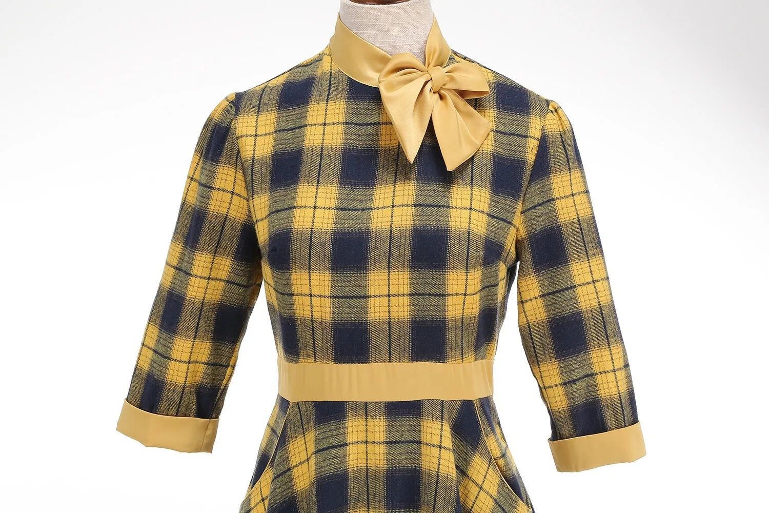 Yellow and black grid plaid turtleneck bow high waist swing dress on display showing full skirt and bow detail