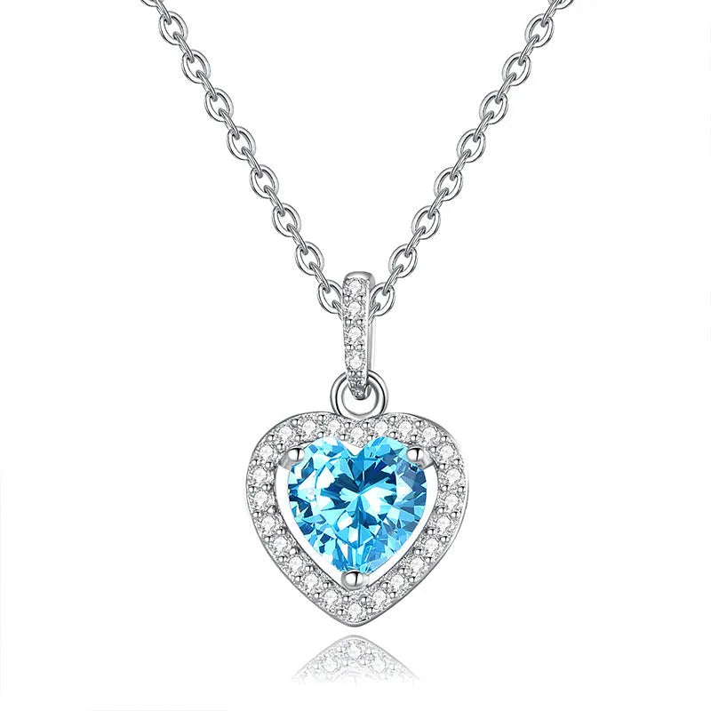Women's sterling silver necklace with heart-shaped gemstone pendant on adjustable cross chain