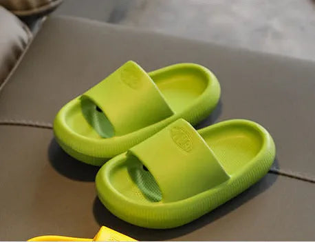 Bright coloured children's EVA slippers with textured sole, shown in blue, green, orange, pink, and yellow.