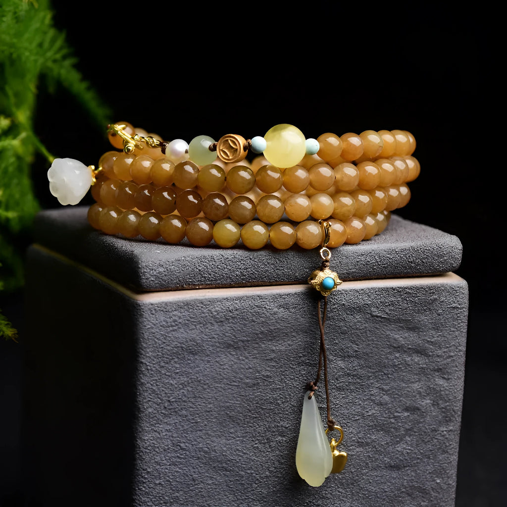 Women's jade bracelet with 6mm round beads showing clear water green pine pattern and leaf sequin accents