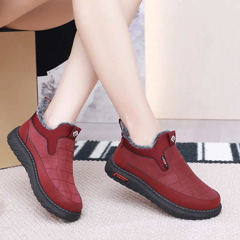 Women's black casual flat boots with a round toe and low-top synthetic leather upper.