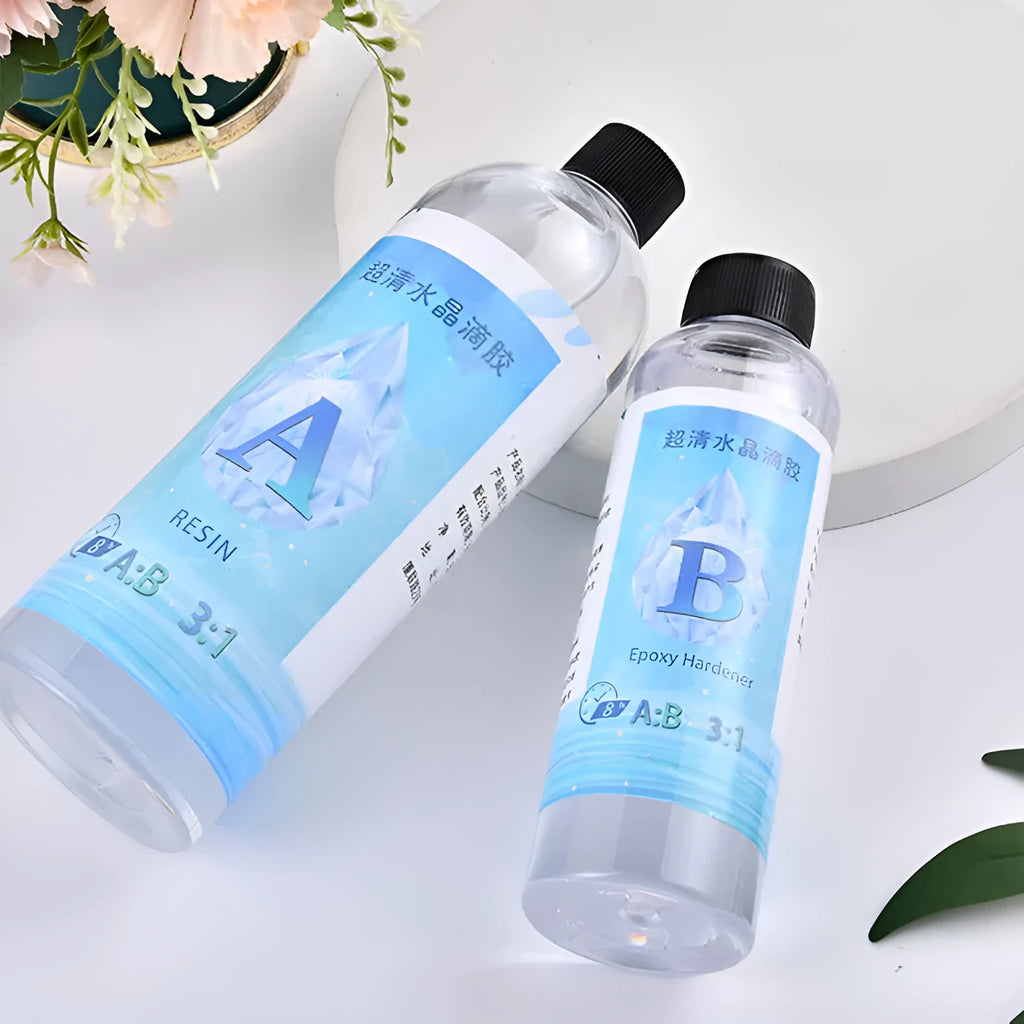 1kg bottle of clear epoxy resin glue and a smaller bottle of crystal drops for DIY crafts.