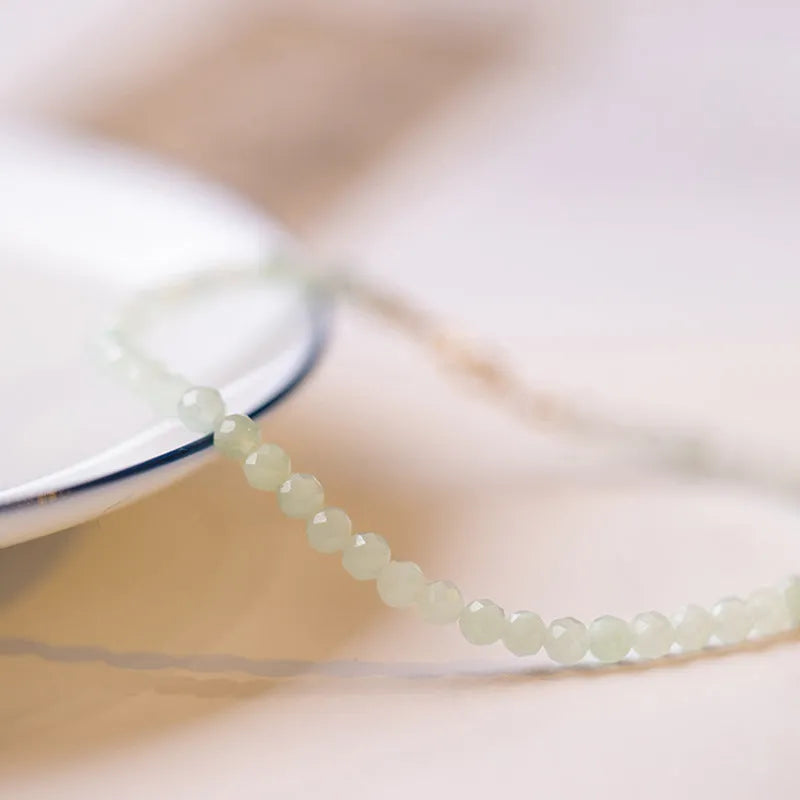 Women's Korean style retro jade ball bracelet on a wrist, showing the bead detail and chain clasp.