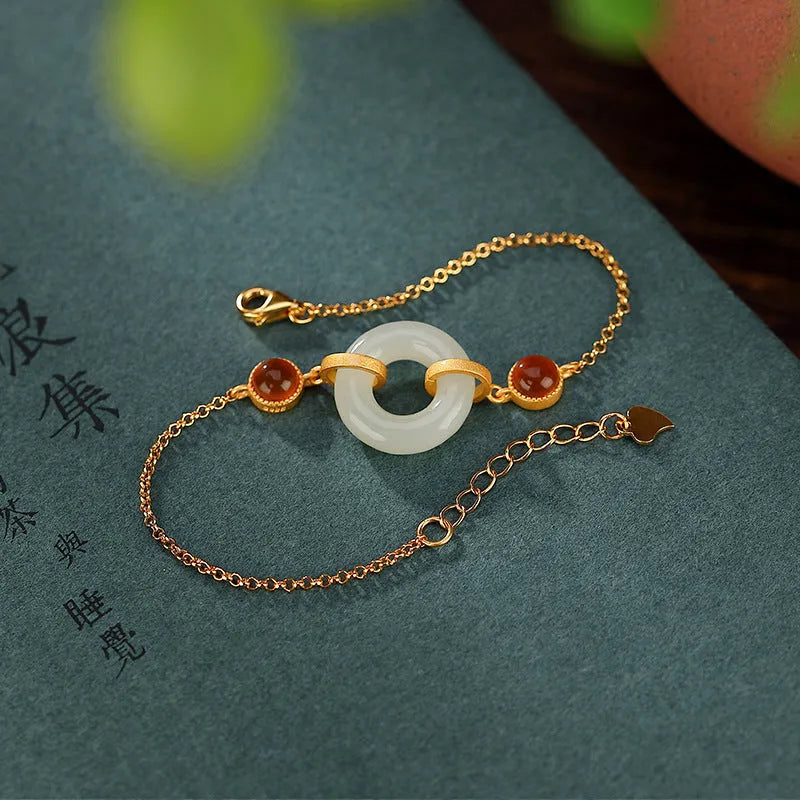 Gold-coloured women's bracelet made of S925 sterling silver with a natural Hetian jade peace buckle charm.