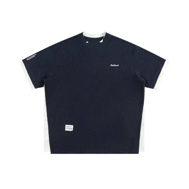 Retro alphabet embroidered loose fit short-sleeved waffle t-shirt on a hanger.