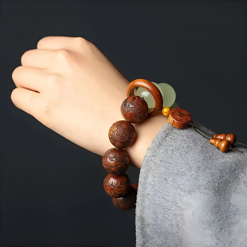 Rosewood bracelet with carved Fu character and amass fortunes design showing 12 wooden beads