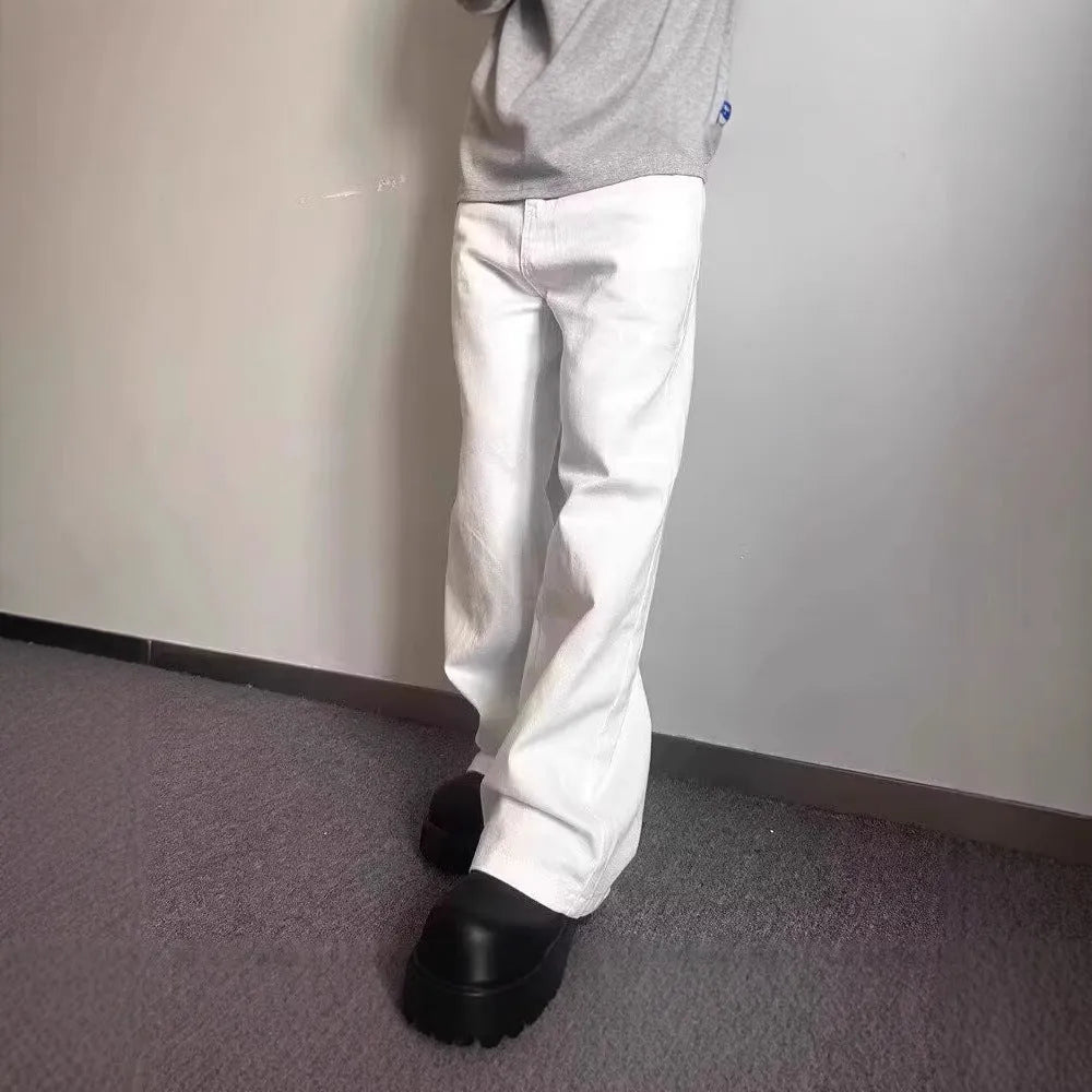 Men's white straight-leg denim jeans with a wide fit and mid-rise waist on a plain background.