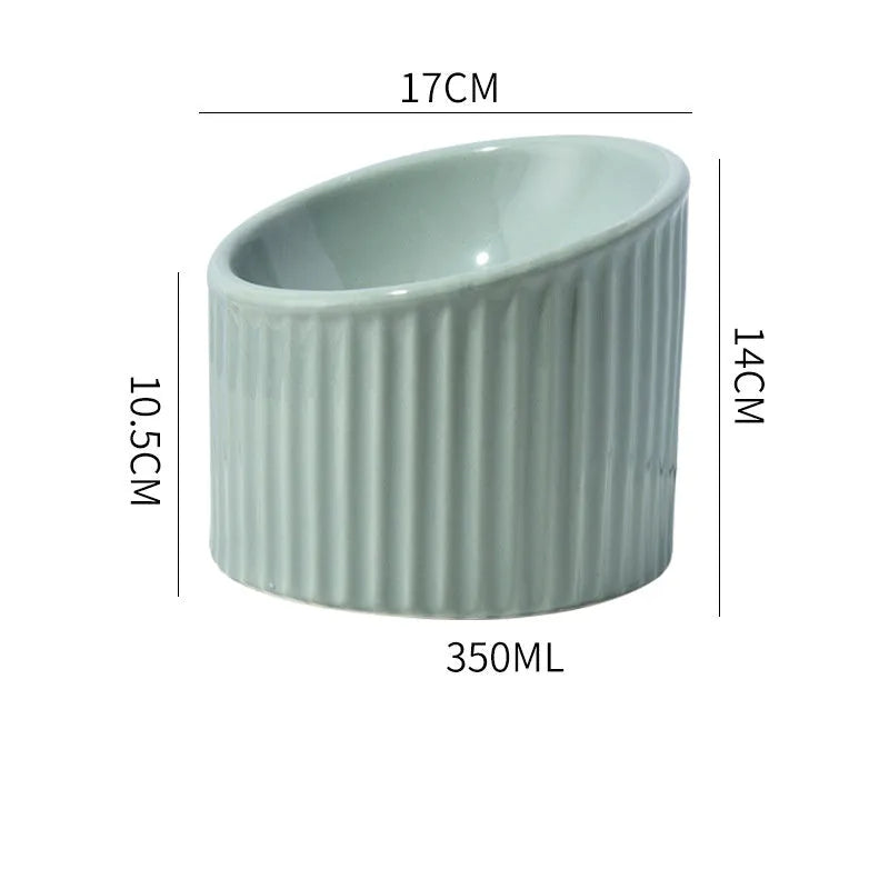 Dark green ceramic elevated cat bowl with tilted design on a raised platform.
