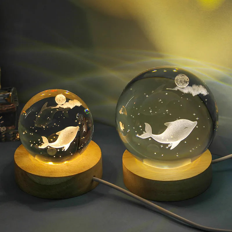 Transparent crystal ball night lamp with 3D carved jellyfish design, on a round base with USB cable.