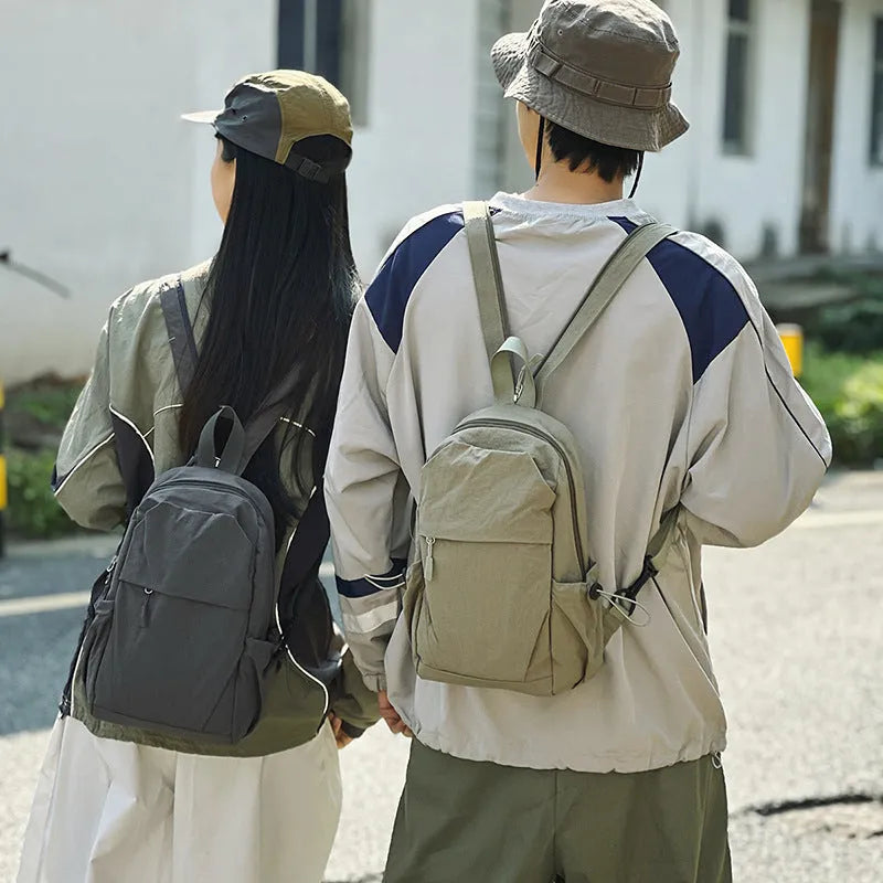 Waterproof nylon backpack in black, green, grey, or white, free size, crossbody or chest bag for outdoor travel.