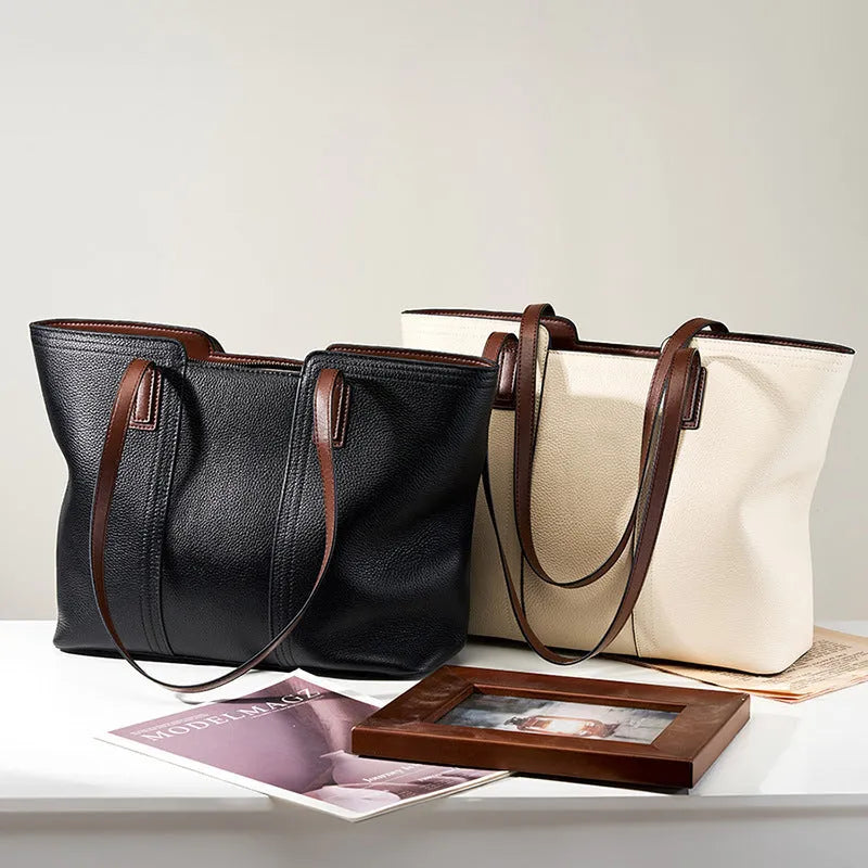 Women's black cowhide leather crossbody bag showing multiple internal compartments including phone pocket and file storage