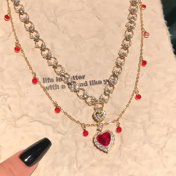 Red love heart pendant on a double layer alloy necklace with an adjustable chain.