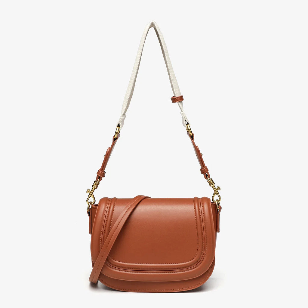 New women's crossbody bag with wide shoulder strap in PU leather, round flap shape, available in black