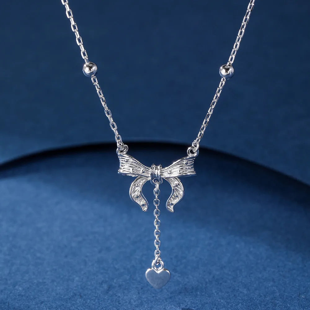 S925 silver adjustable clavicle chain with heart pendant featuring butterfly and bow design