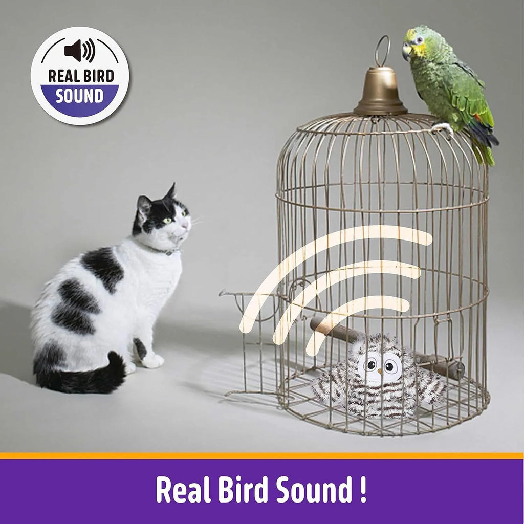 Grey automatic chirping owl cat toy with flapping wings on a flat surface.