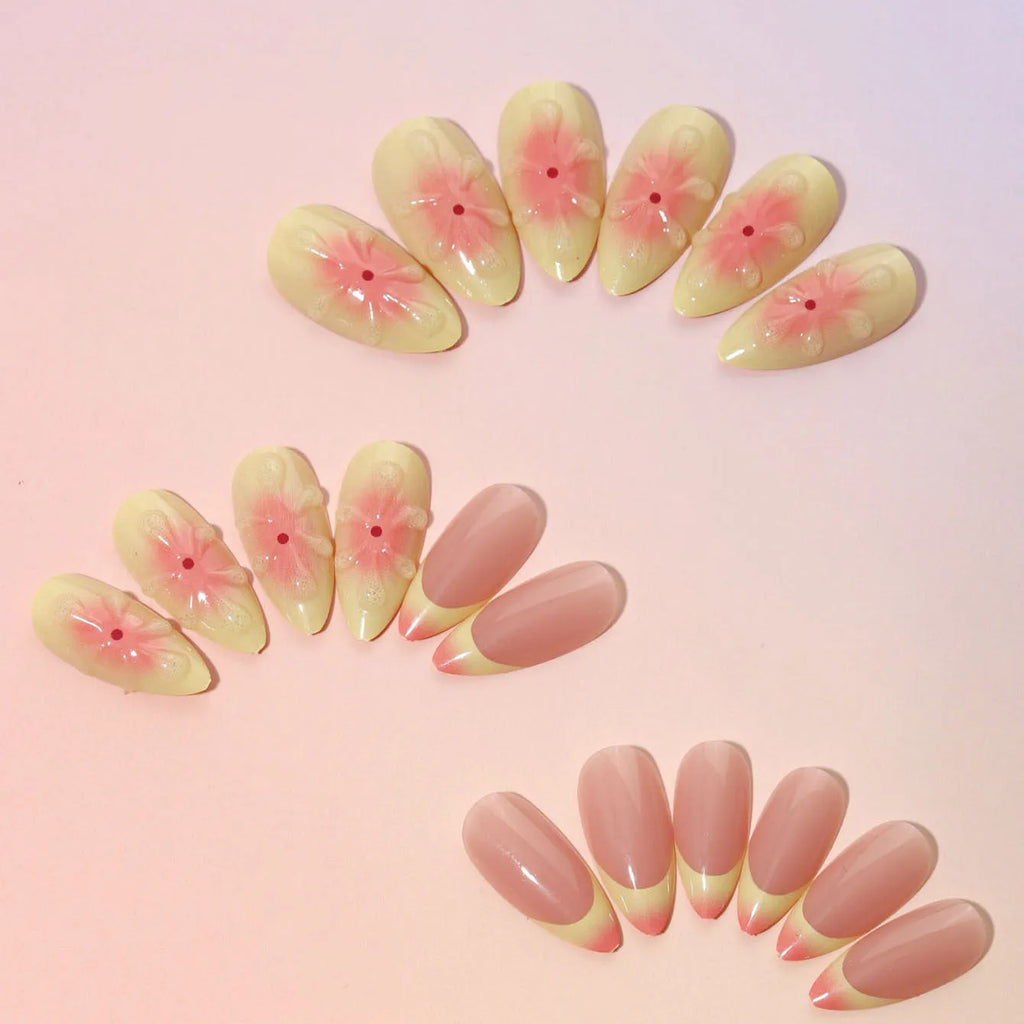 Set of plastic false nails with raised 3D cartoon flowers, jelly glue pot, and a nail file.