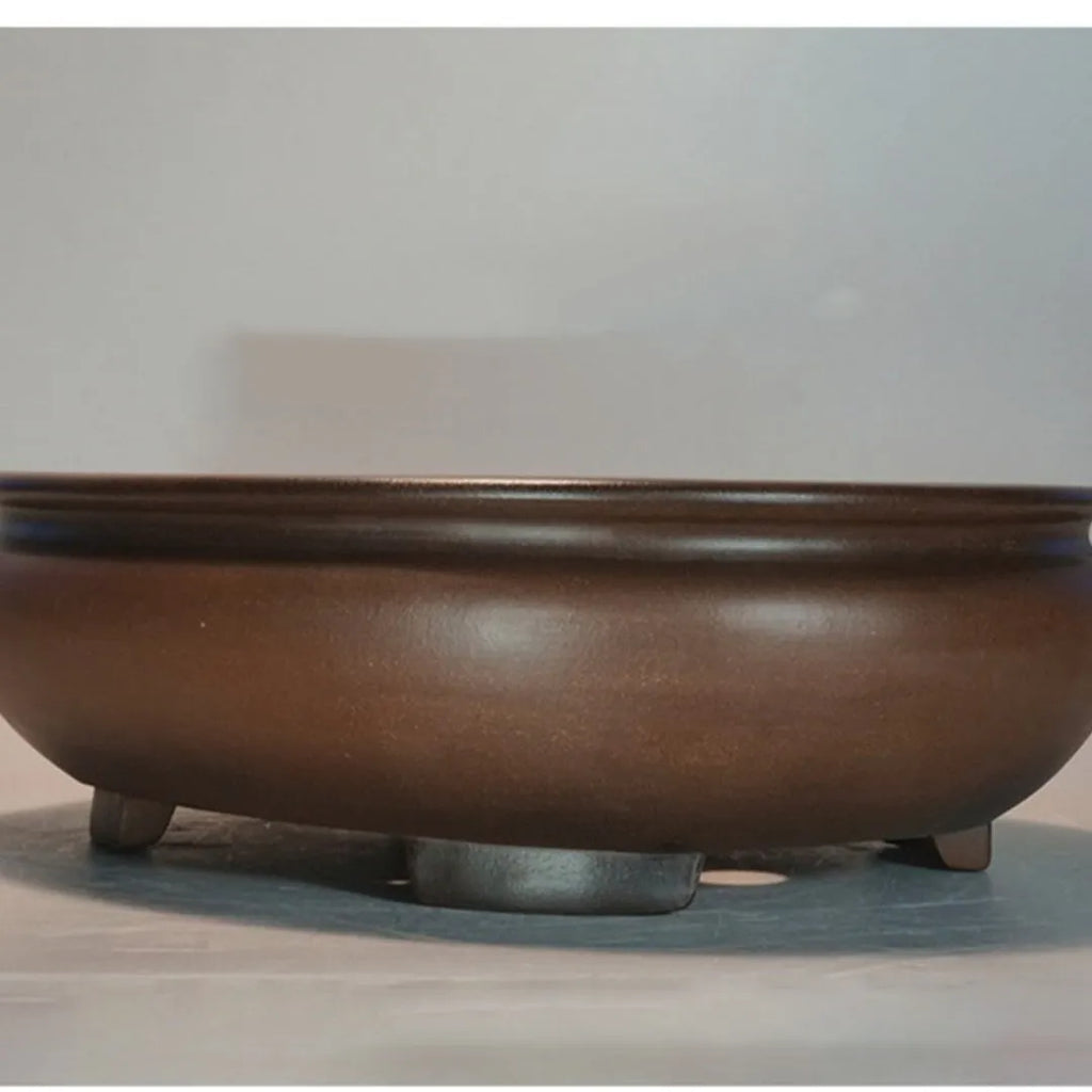 Handmade purple clay classical style desktop flowerpot on a wooden surface
