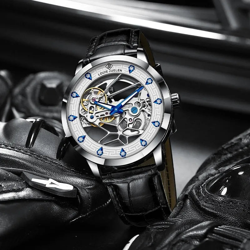 Men's silver mechanical watch with white dial, blue hands, and black leather strap on wrist