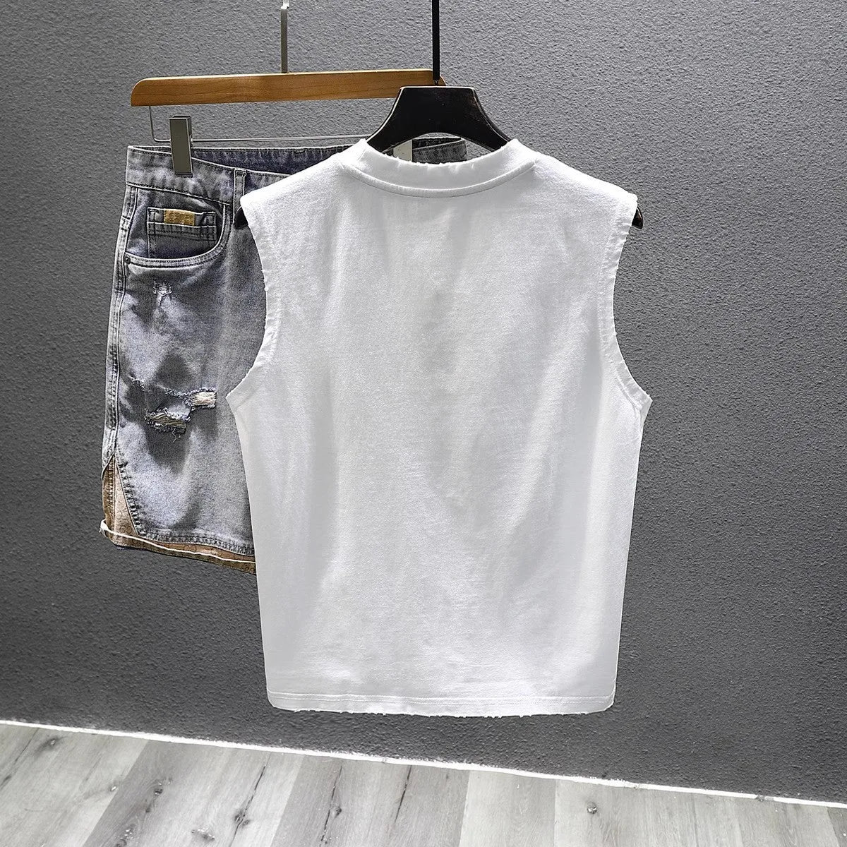 Women's solid black cotton sleeveless t-shirt with a loose fit and straight hem.