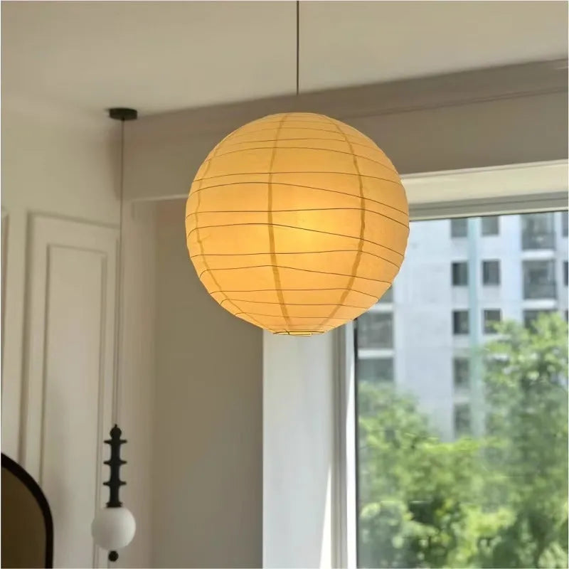 Japanese rice paper chandelier in living room setting with soft ambient lighting