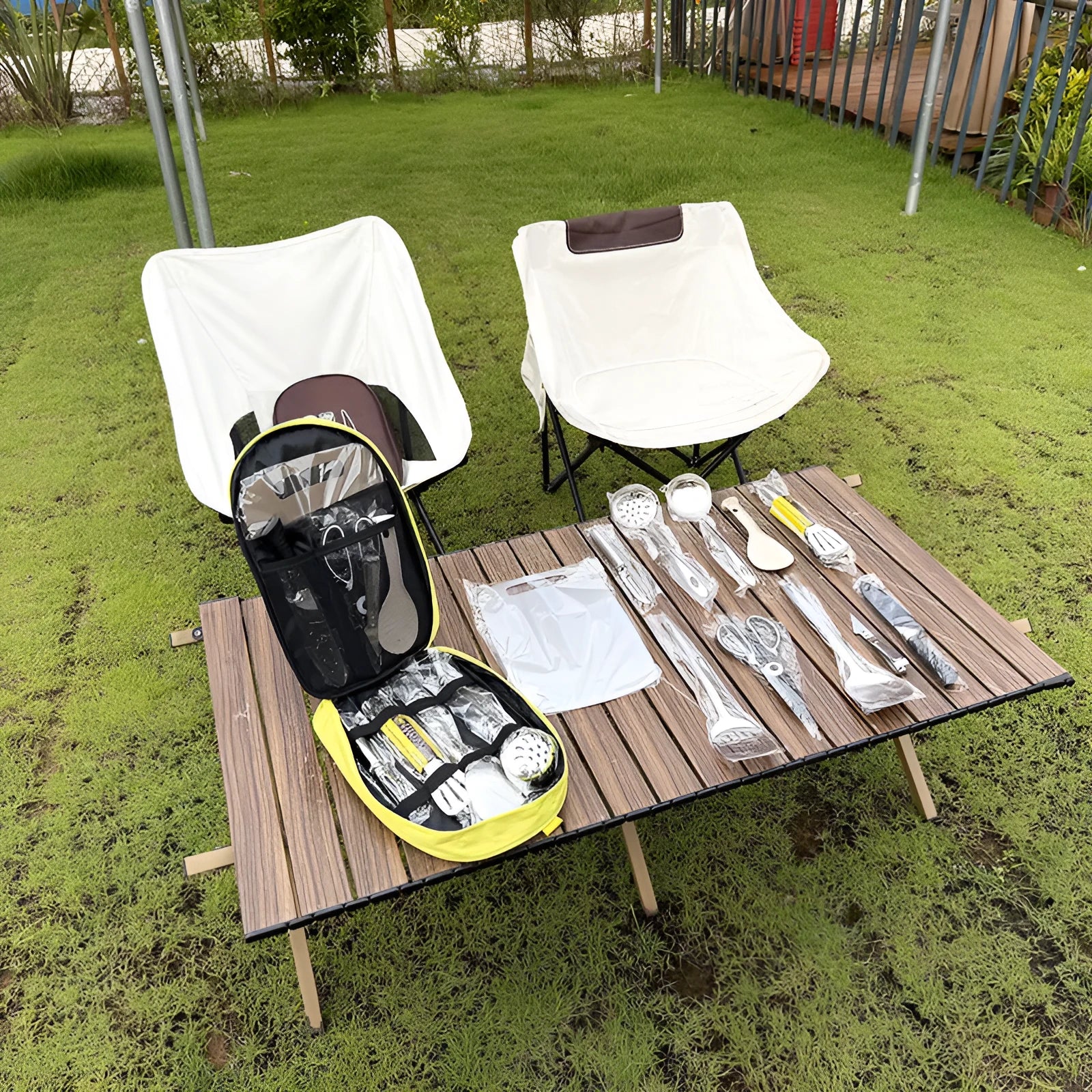 Multi-functional portable picnic bag containing a 12-piece stainless steel kitchenware set for outdoor dining.