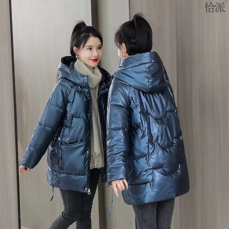 A woman wearing a loose-fit forest green hooded winter jacket, showcasing its relaxed silhouette and long sleeves.