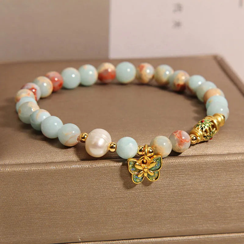 Blue women's bracelet with Shoushan Stone and freshwater pearl butterfly design featuring adjustable closure