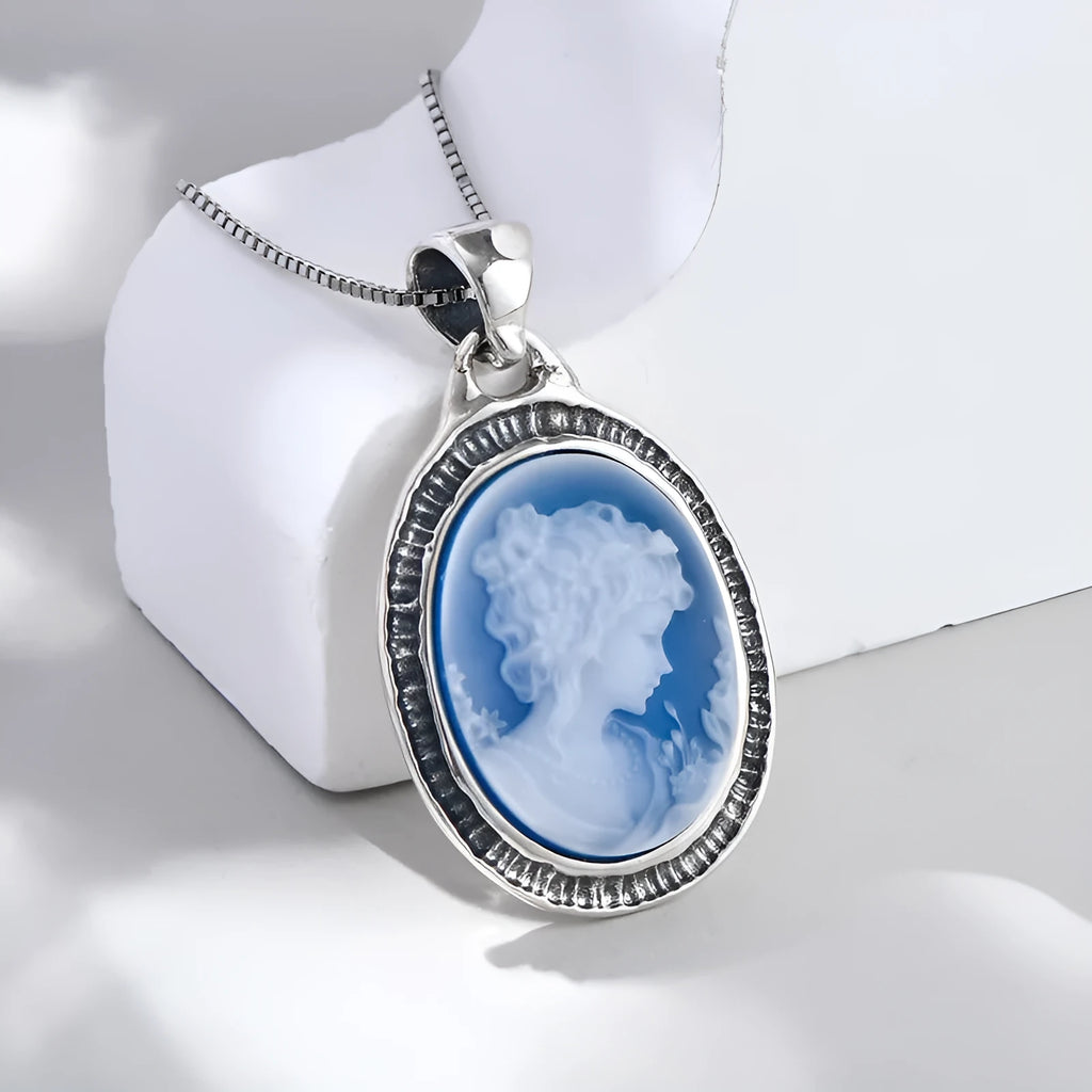 S925 sterling silver pendant with embossed blue and white agate oval portrait on white background