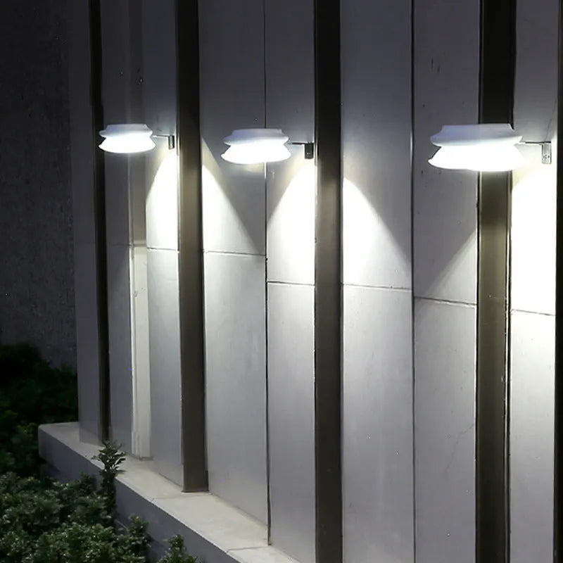Solar-powered outdoor fence wall lamp with Southeast Asian design mounted on garden fence