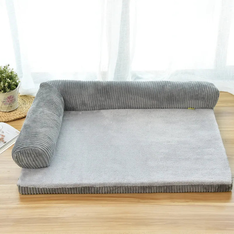 Corduroy dog sofa bed with bolster sides on a wooden floor, showing grey colour option in large size.
