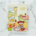 A5 paperbound notebook with thread binding, open to show flat lay, with choice of Eating Ice Cream, Reading, Traveling, or Outing cover designs.
