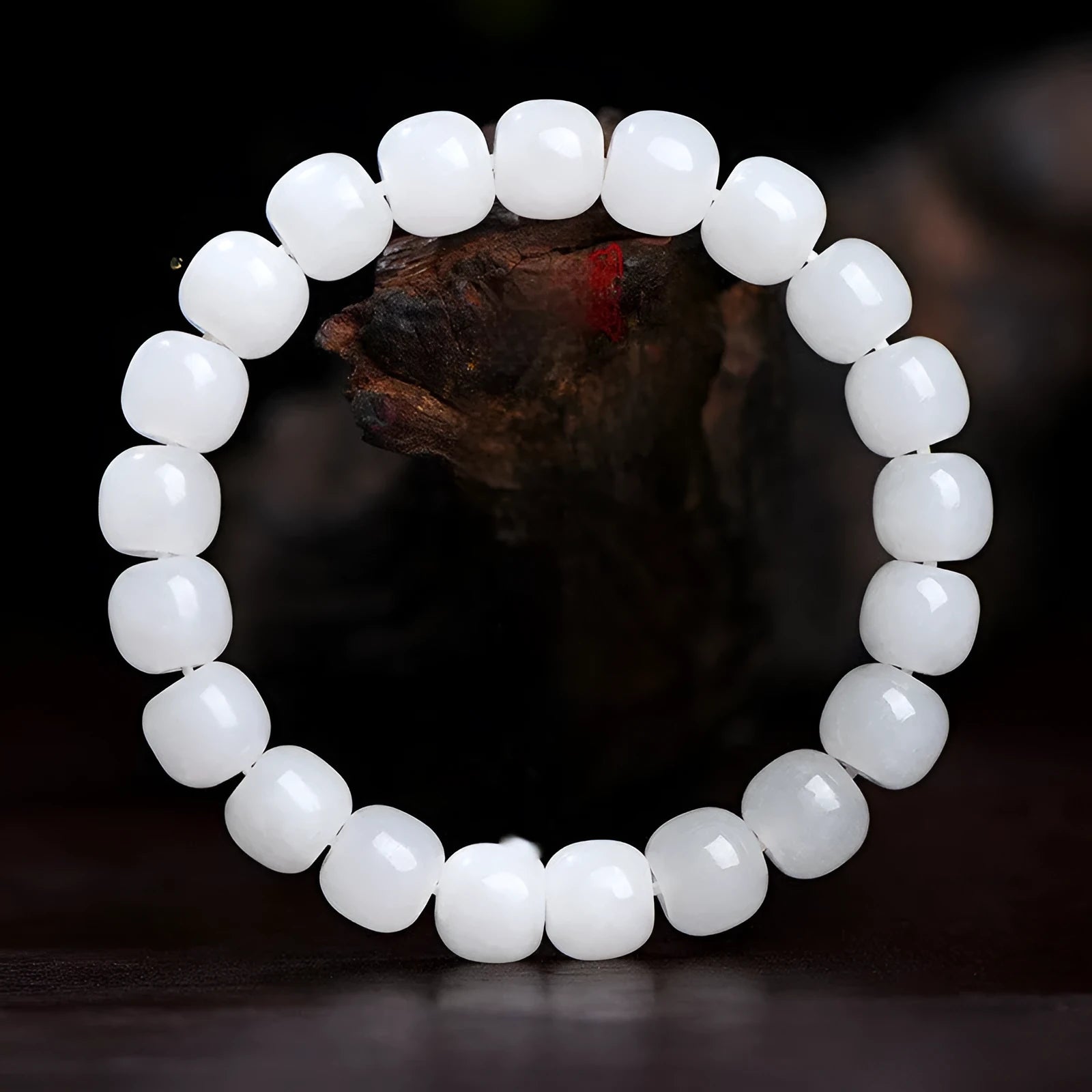 White Hetian jade barrel bead bracelet showing smooth, polished beads on a wrist.