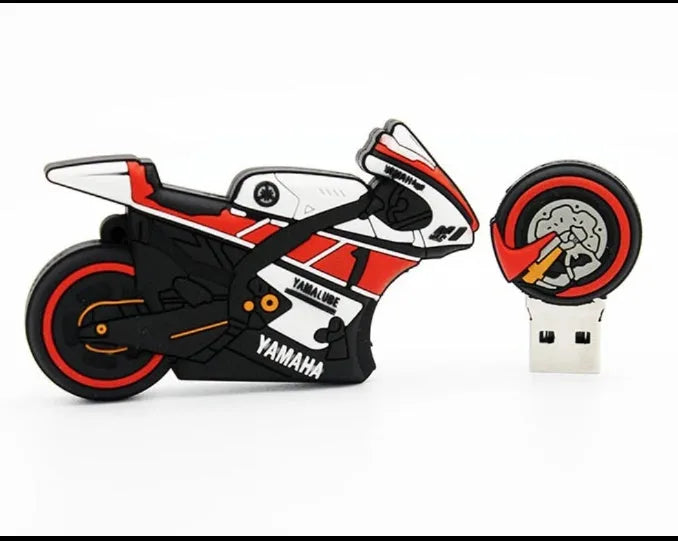 Cartoon motorcycle USB drive with red white wristband and key ring on a surface