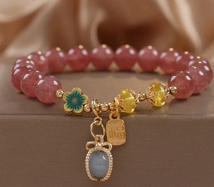 Red women's beaded bracelet with a strawberry quartz centre stone and sparkling rhinestones on an alloy chain.
