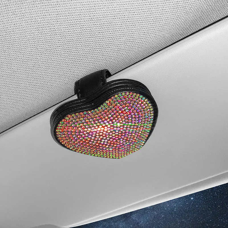 A black PU leather magnetic storage clip with a diamond pattern on a car sun visor, holding a pair of sunglasses.