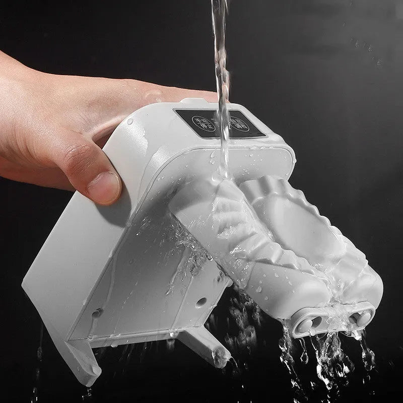 White automatic electric dumpling maker machine with USB charging cable, brush, and spoon on a kitchen counter.