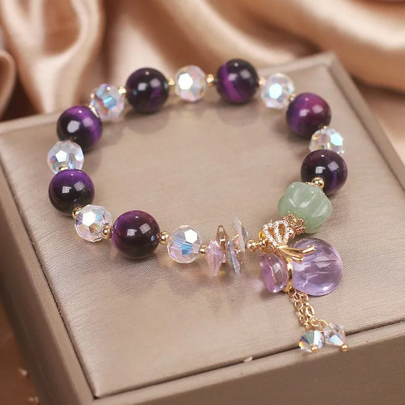 Women's forest style bracelet with purple tiger eye money bag pendant and rhinestone crystal details